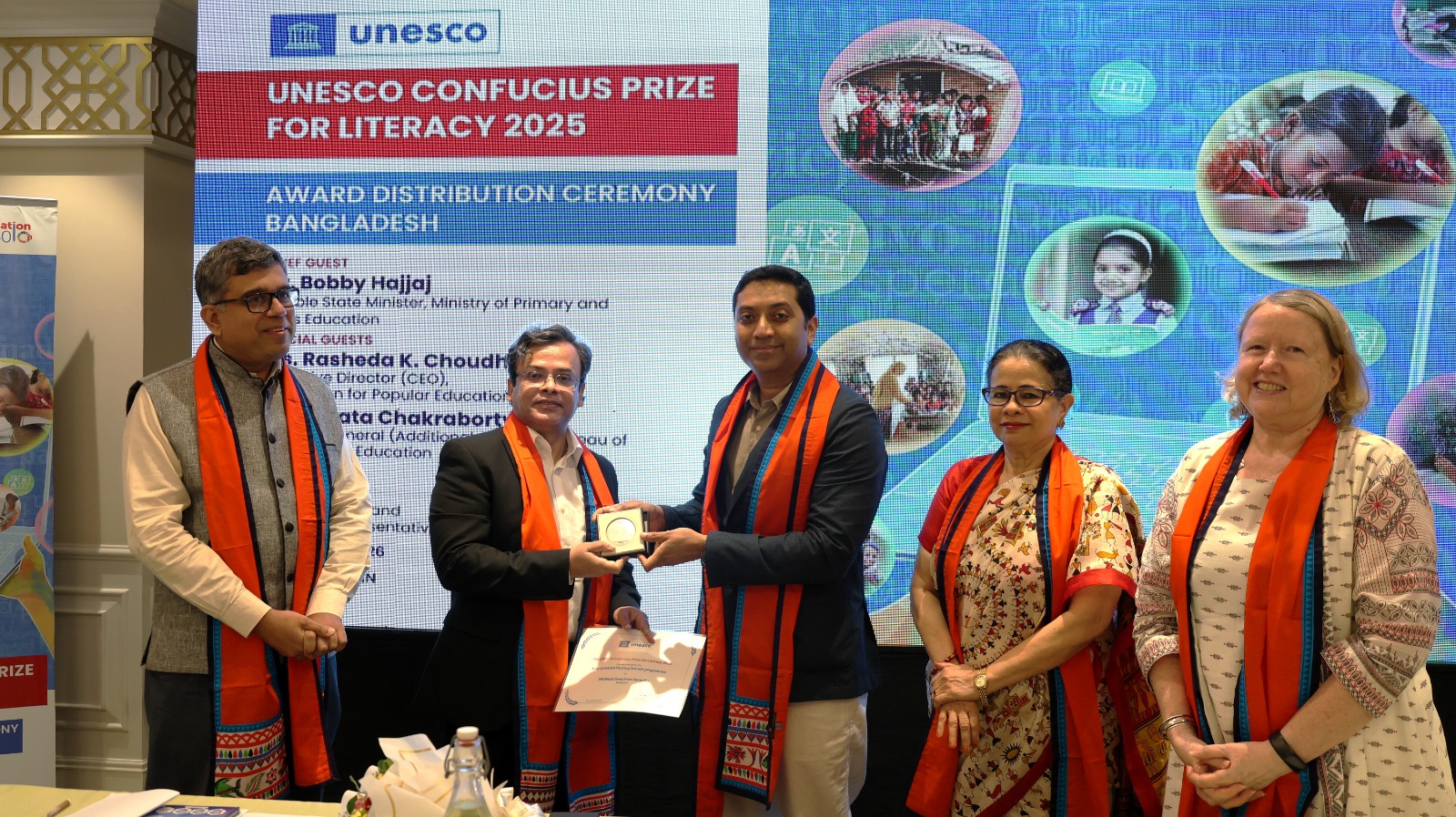 Mohammad Rezwan receives the UNESCO Confucius Literacy Award from the State Minister for Education at the Holiday Inn Dhaka City Center on Wednesday afternoon.